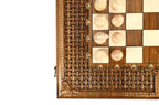 Corner detail of the open-cut braid carving, bronze studs and light chess pieces