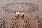 Close-up of the carved wheel ornament and dice on the epoxy-finished backgammon field