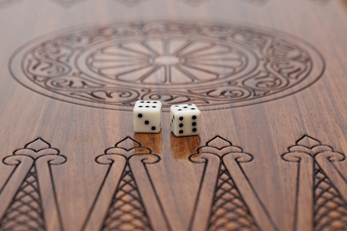 Close-up of the carved wheel ornament and dice on the epoxy-finished backgammon field