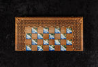 Top view of handcrafted walnut chess backgammon board with blue amber epoxy squares and carved basket-weave frame