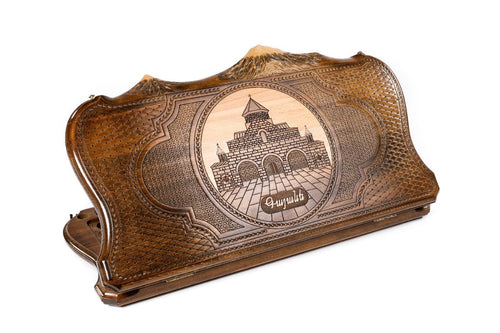 Side-by-side view of the closed wooden backgammon case showing the St. Gayane Church carving and the Mount Ararat silhouette.
