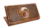 A top-down view of the closed wooden backgammon board featuring the carved Eternity wheel and intricate braid borders.