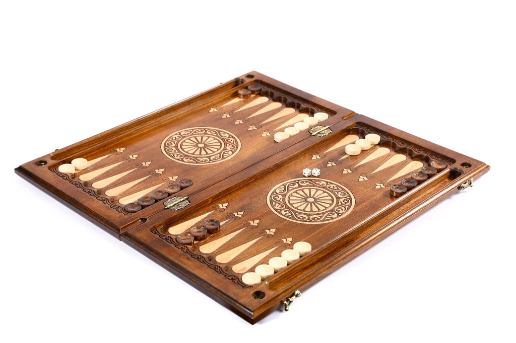 Close-up of the carved horse motif and detailed braid patterns on the backgammon set exterior.