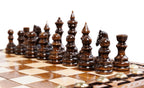 Carved chess and backgammon set - close-up of hand-carved chess pieces