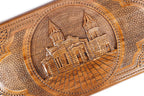The interior of the open backgammon set highlighting the smooth wood grain and the precisely inlaid playing pips.