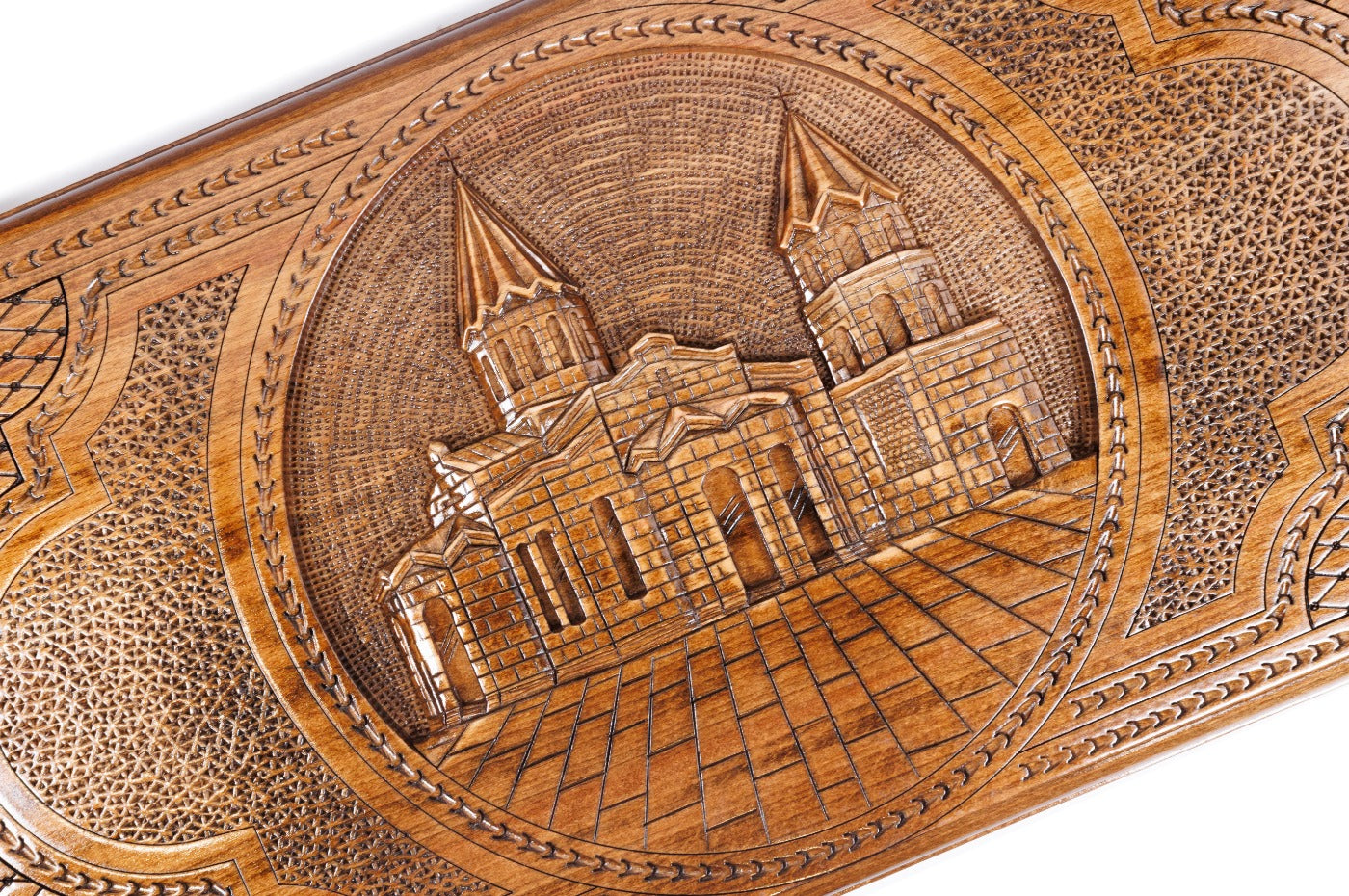 The interior of the open backgammon set highlighting the smooth wood grain and the precisely inlaid playing pips.
