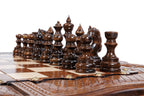 Dark hand-carved chess pieces on the walnut and hornbeam squares of the large chess board