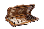 Walnut chess backgammon set half open with the hand-carved pieces stored on the backgammon field