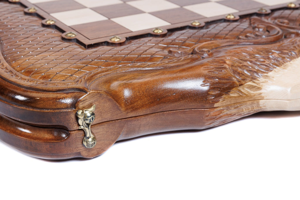 Corner detail of the carved braid frame, bronze clasp and hornbeam inlay on the walnut board