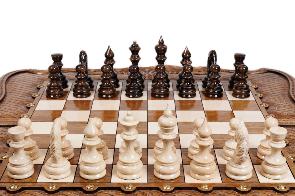 Front view of the luxury walnut chess set with all 32 hand-carved pieces in starting position