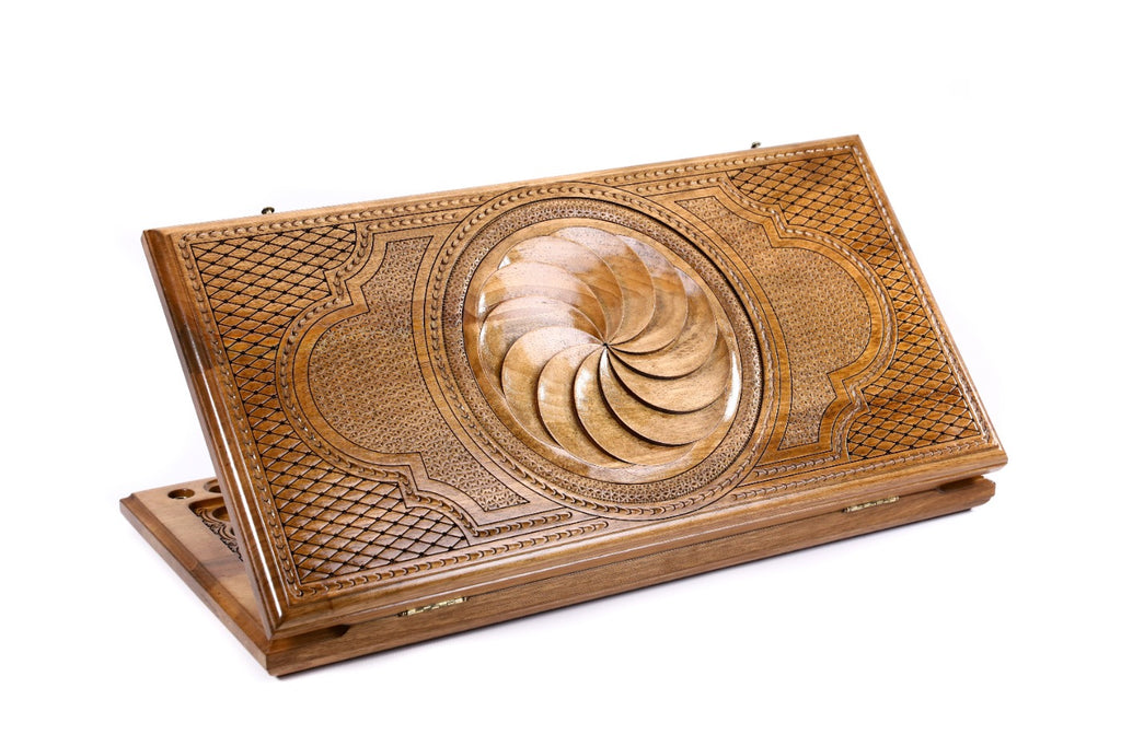A frontal view of the closed Eternity classic backgammon board by Hrachya Ohanyan showing the hand-carved Arevakhach symbol.