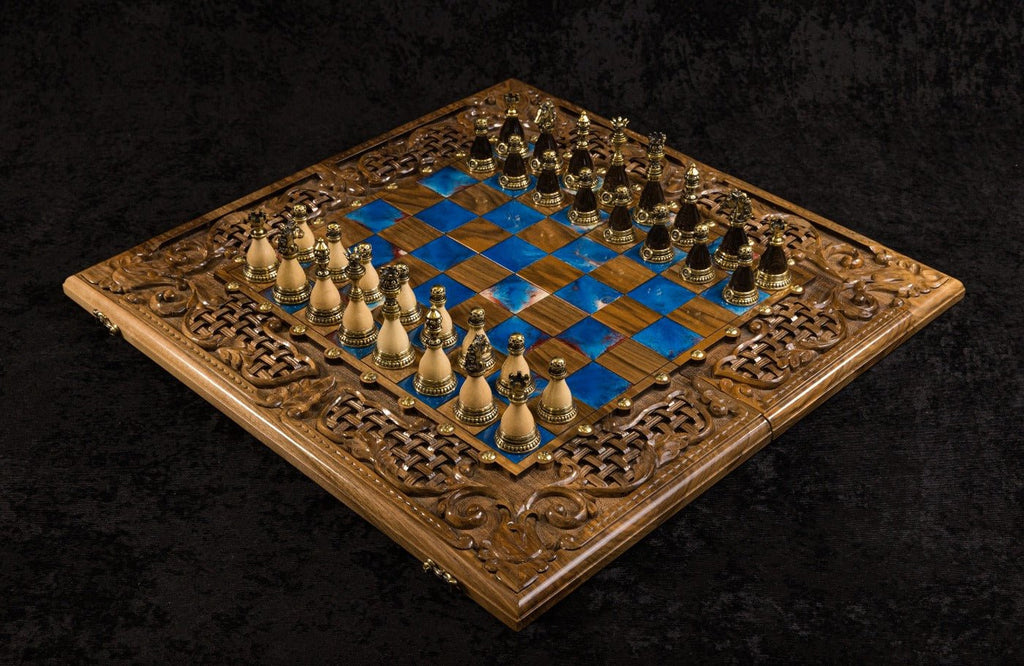 Luxury wooden chess set in solid walnut with blue epoxy resin squares, ornamental braid border and  unique chess pieces — by Hrachya Ohanyan