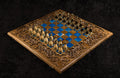 Luxury wooden chess set in solid walnut with blue epoxy resin squares, ornamental braid border and  unique chess pieces — by Hrachya Ohanyan