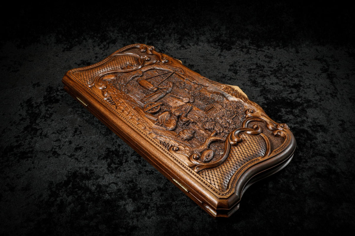 Village scene backgammon set closed, angled view of the deep-relief lid and scroll frame