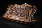 Village scene backgammon set closed, front view of the carved scene in its rococo scroll frame
