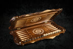 Walnut backgammon board opened flat, pale inlaid points and wheel ornaments on each half