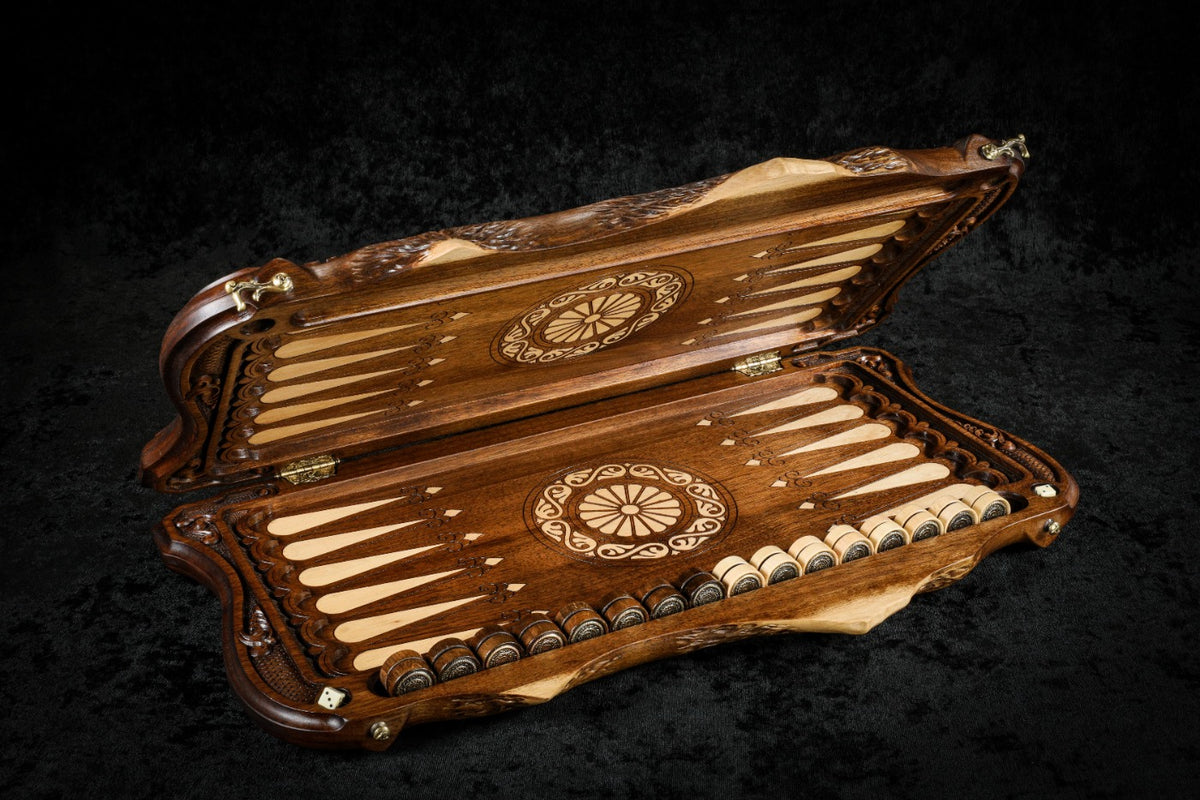Walnut backgammon board opened flat, pale inlaid points and wheel ornaments on each half