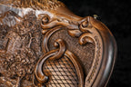 Scroll of the carved frame with the faceted lattice and the deep-relief foliage, close-up
