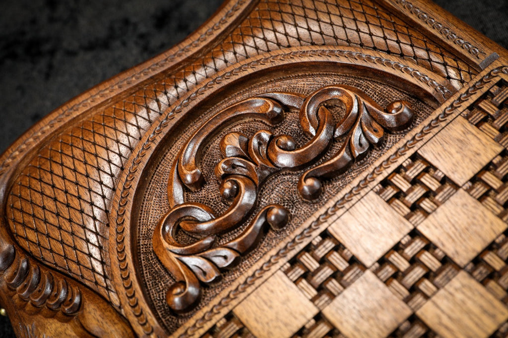 Basket weave carved in relief beside the scroll ornament on the back cover, close-up