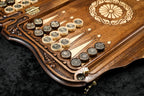 Ornament checkers with cast emblems on the hornbeam-inlaid points, wheel ornament beside them