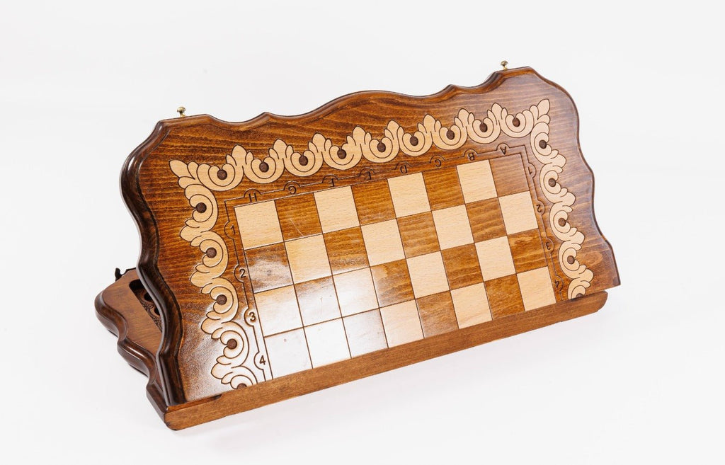 Wooden chessboard with decorative border on a white background