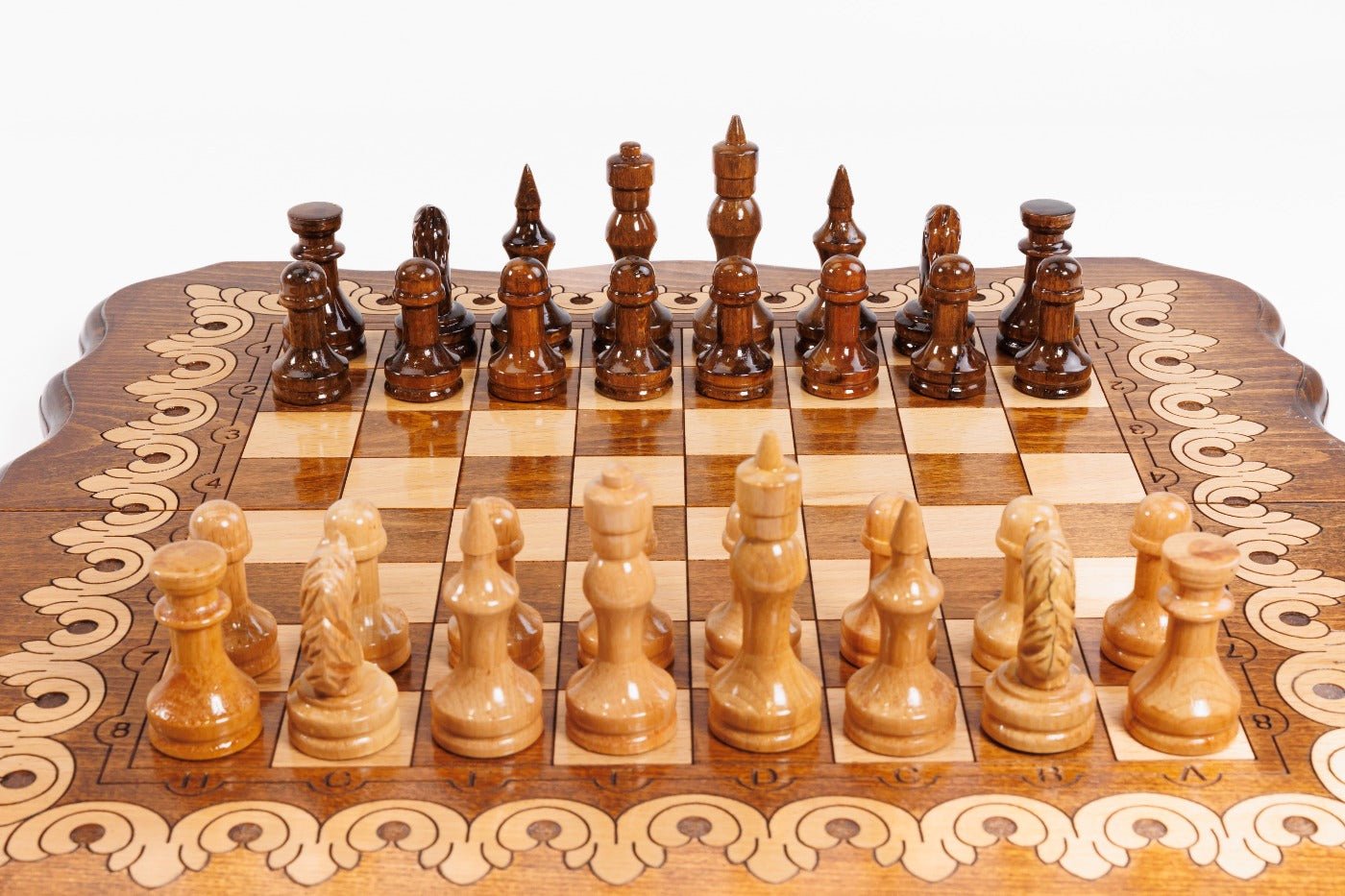 Wooden chess set with pieces on a checkered board