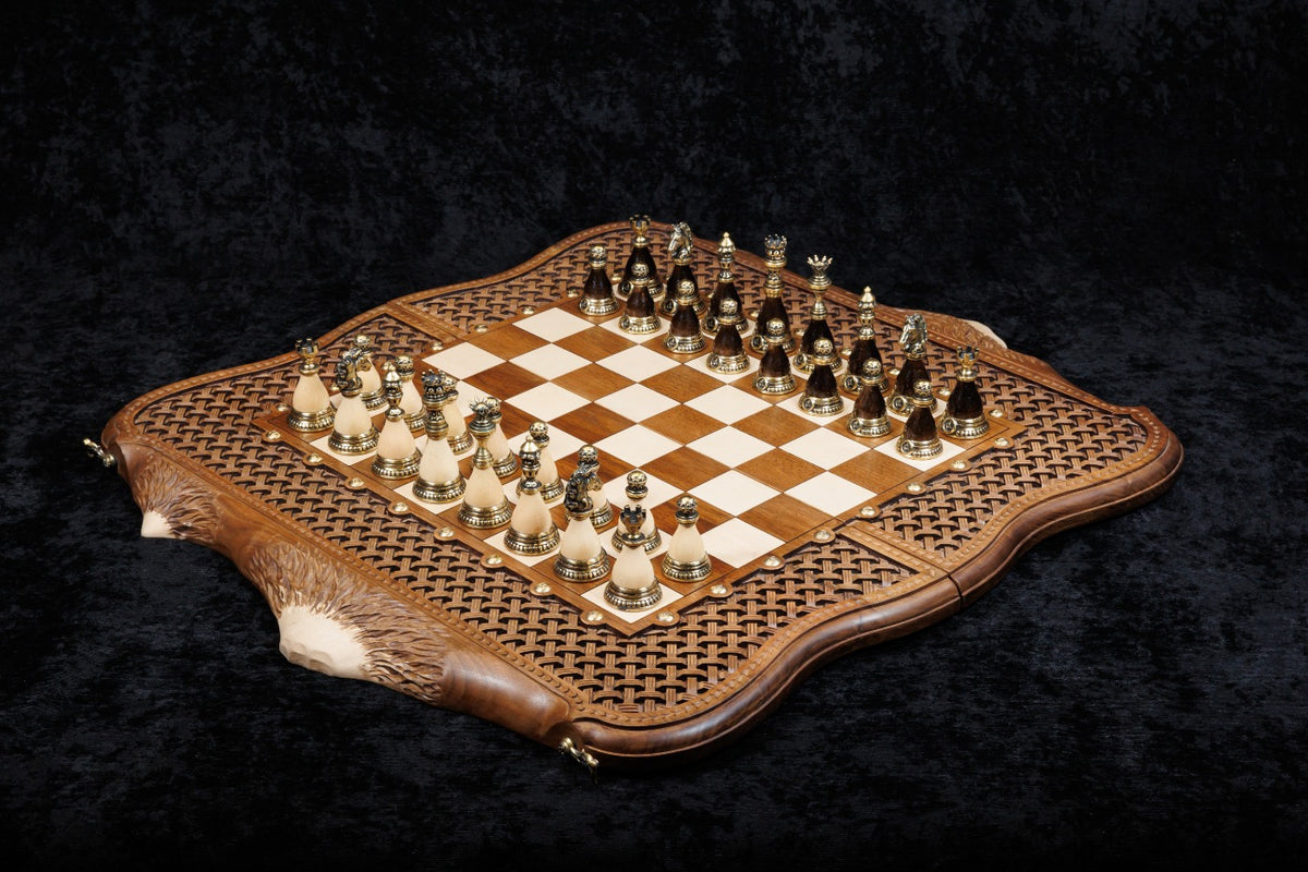 Luxury walnut chess and backgammon set with bronze pieces set up on the hornbeam chessboard in its basket-weave frame, 60 cm