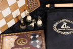 Bronze chess pieces beside the Hrachya Ohanyan checkers box and black carrying case