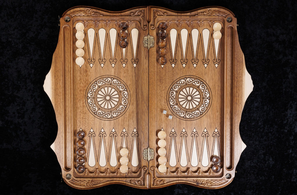 Backgammon board open from above: hornbeam-inlaid points and wheel ornaments on the walnut field