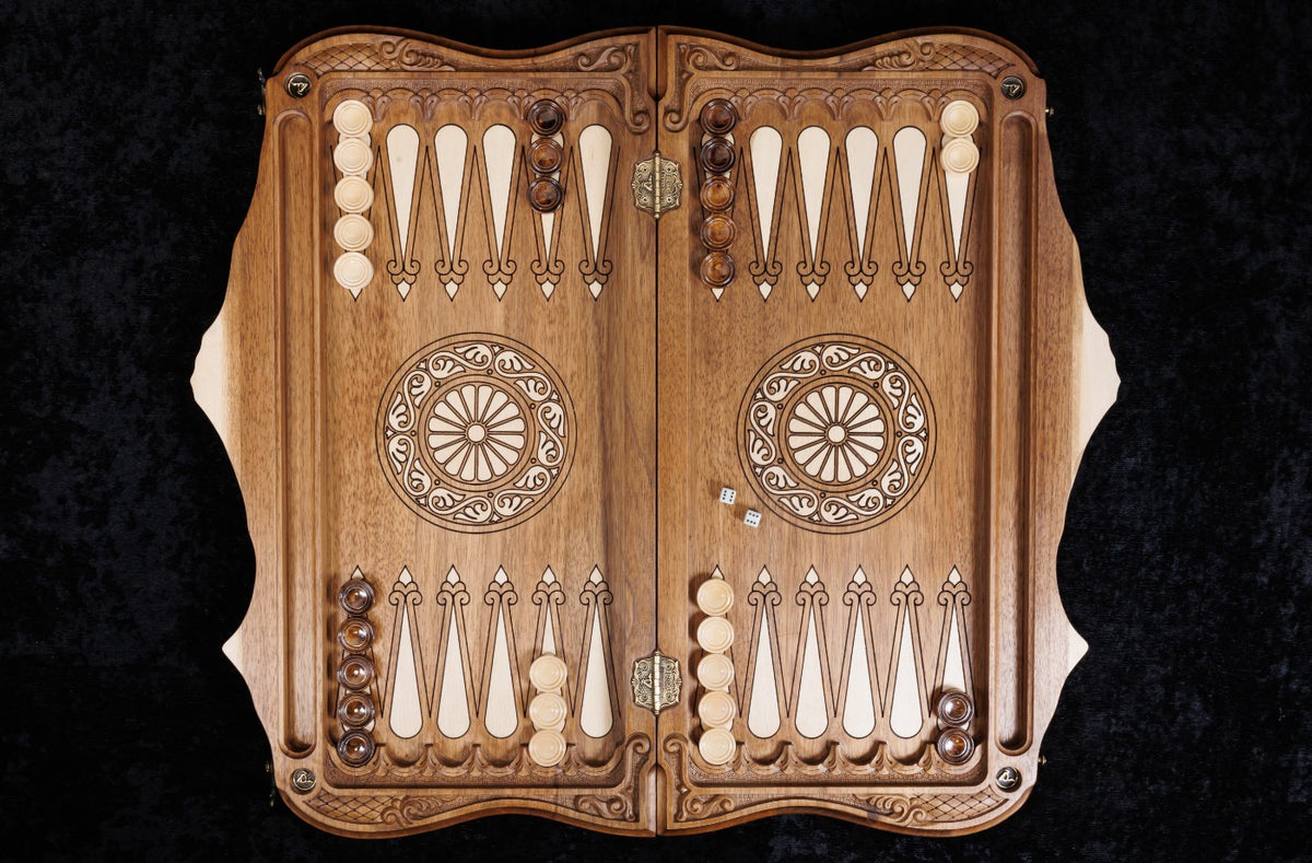 Backgammon board open from above: hornbeam-inlaid points and wheel ornaments on the walnut field