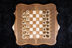 Chessboard of the set from above with all 32 bronze pieces in their starting squares