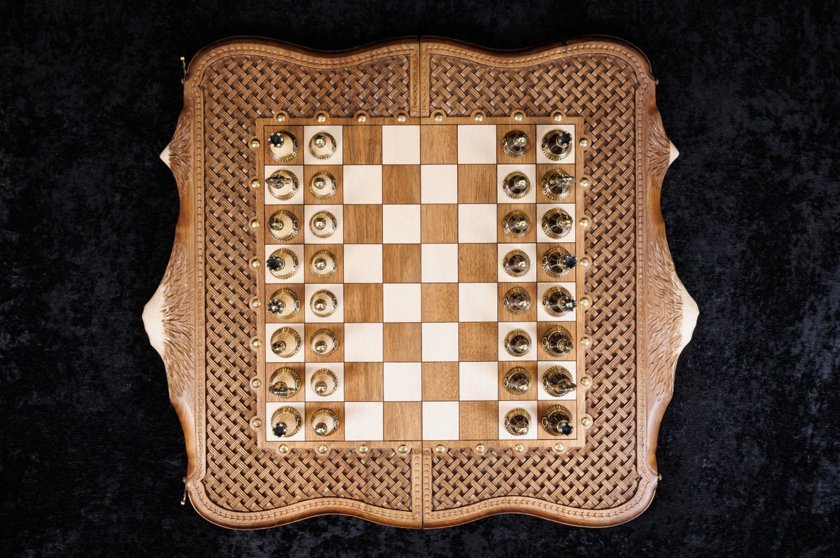 Chessboard of the set from above with all 32 bronze pieces in their starting squares