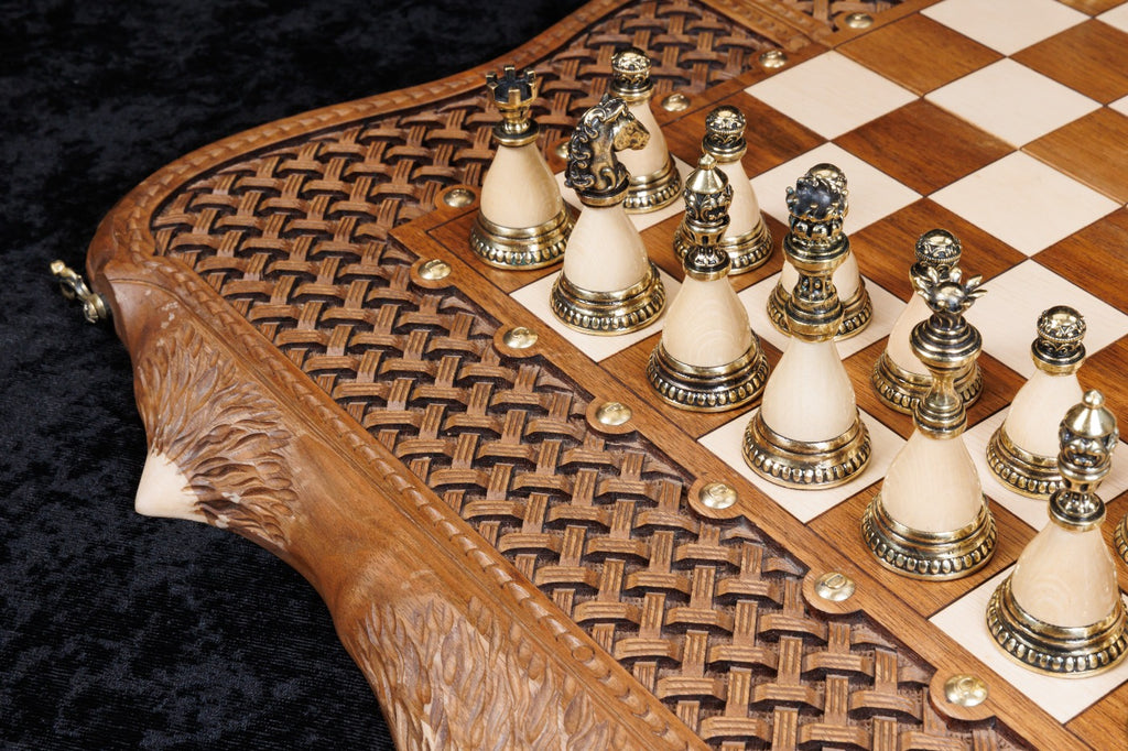 Bronze chess pieces set up on the chessboard with the carved live edge in front