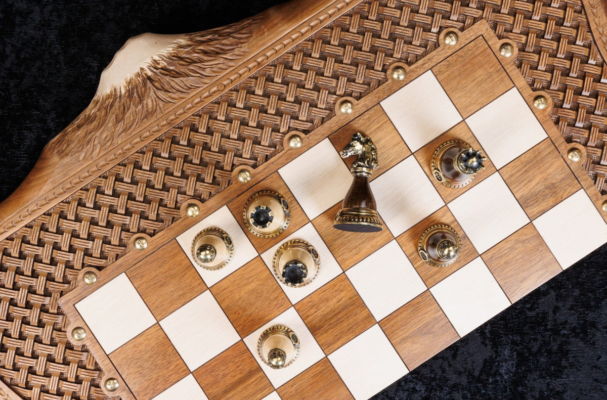 Bronze pawns and pieces on the hornbeam squares of the chessboard, close-up from above