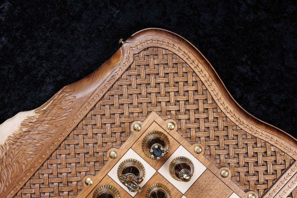 Checkers with cast emblems in the corner of the chessboard beside the braid frame