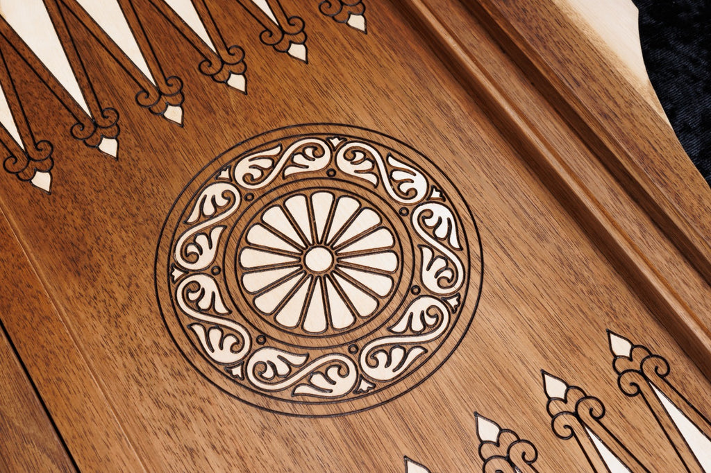 Wheel ornament inlaid in hornbeam on the walnut backgammon field, points beside it