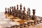 Square Design Bronze Legs chess set - close-up of hand-carved chess pieces