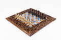 Luxury wooden chess set in solid walnut with blue epoxy resin squares and ornamental braid border — by Hrachya Ohanyan