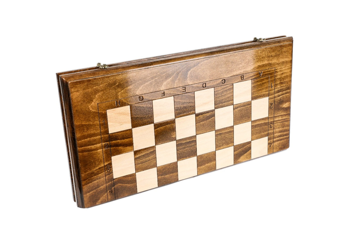Closed wooden chess and backgammon board with smooth frame and carved coordinates