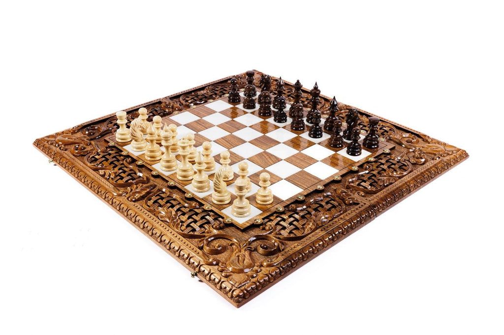Luxury wooden chess set in solid walnut with ornamental braid border, sculpted bird carvings and white epoxy resin squares — by Hrachya Ohanyan