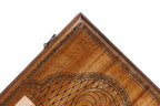 Corner of the lid: faceted lattice, rope border and lobed cartouche on the classic outline board