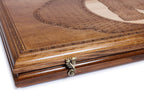 Edge of the closed backgammon board with the cast-bronze clasp and layered lattice lid