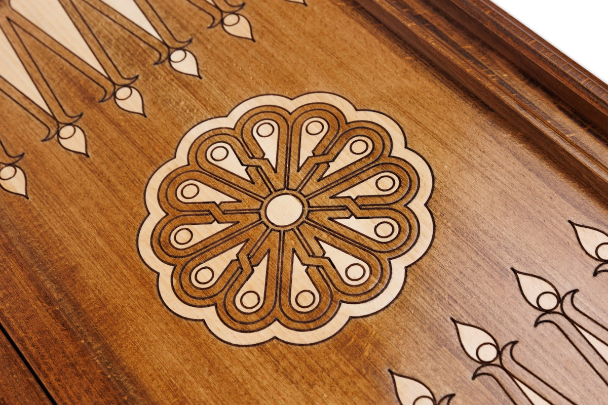 Eight-petal wheel ornament cut into the dark field beside the fleur-de-lys points