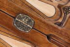 Stamped hinge on the centre bar of the open board with points and a scroll ornament beside it