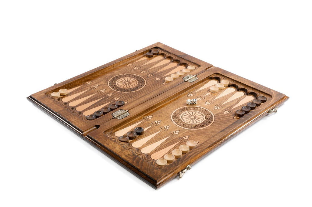 Close-up detail of the carved pomegranate tree pattern on the backgammon set exterior.