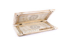 White and gold backgammon board opened flat, points drawn in line and a wheel ornament on each half