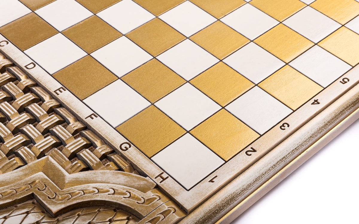 Basket weave carved in relief beside the gold and white squares of the chequerboard, close-up