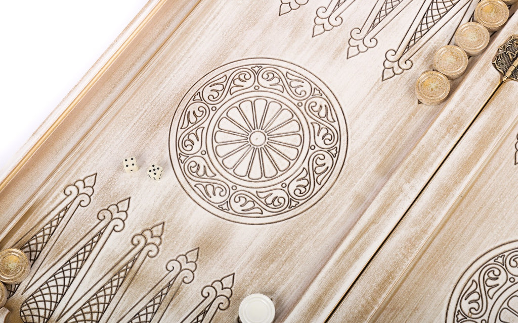 Wheel ornament and two dice on the open white and gold backgammon board, points drawn in line