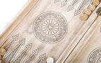 Wheel ornament and two dice on the open white and gold backgammon board, points drawn in line