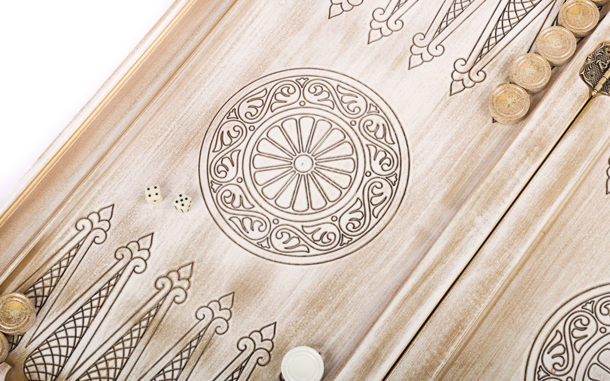 Wheel ornament and two dice on the open white and gold backgammon board, points drawn in line
